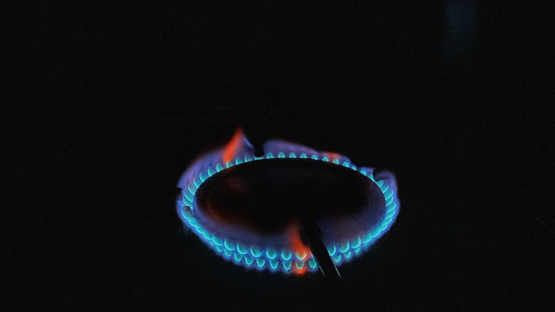 Blue gas flame burning — UK gas and electricity bill costs