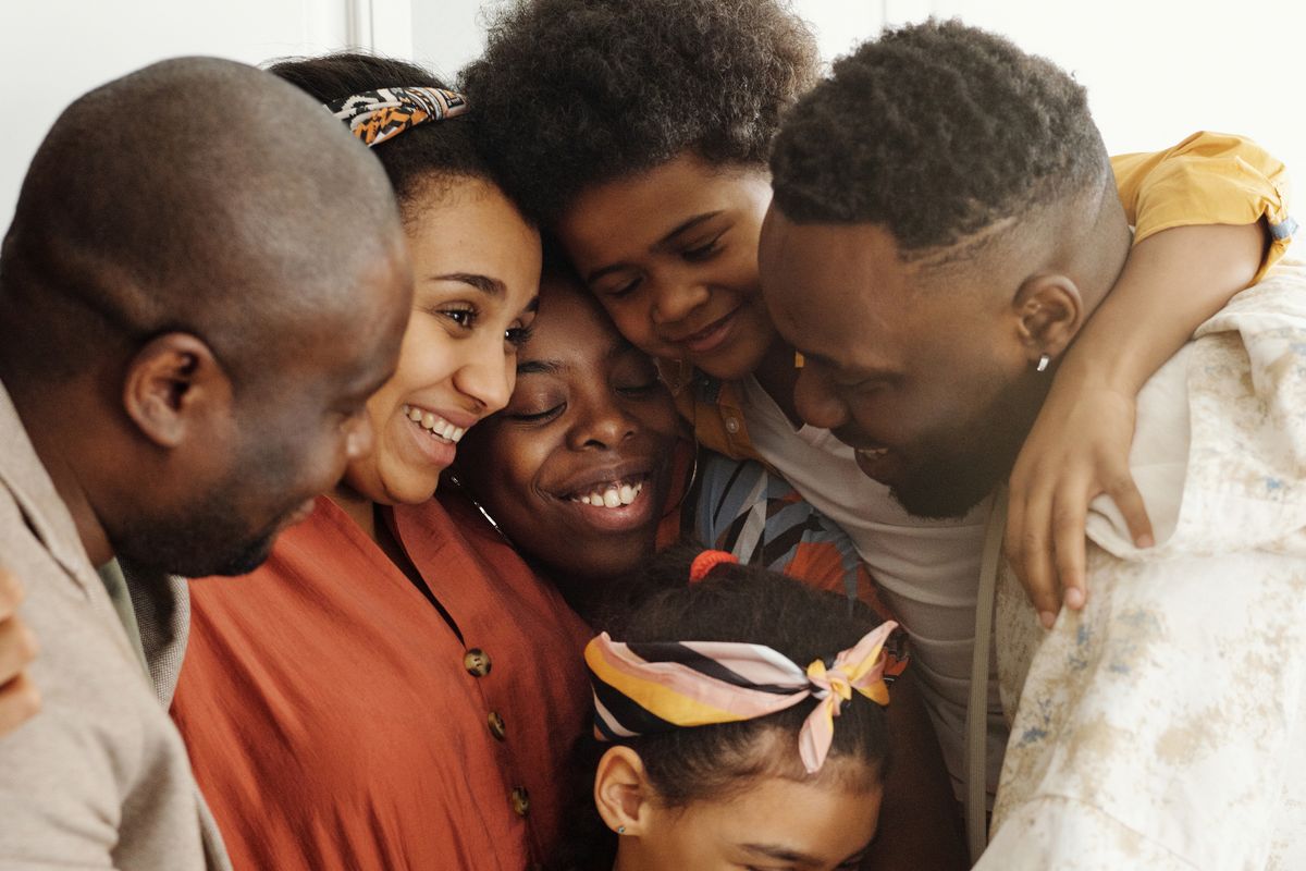 Happy family at home — SaveFirst helps UK families save on bills